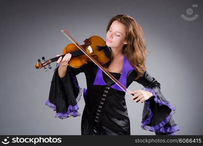 Woman artist with violin in music concept