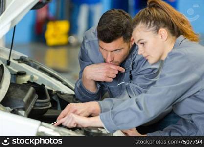 woman as a mechanic in auto repair shop