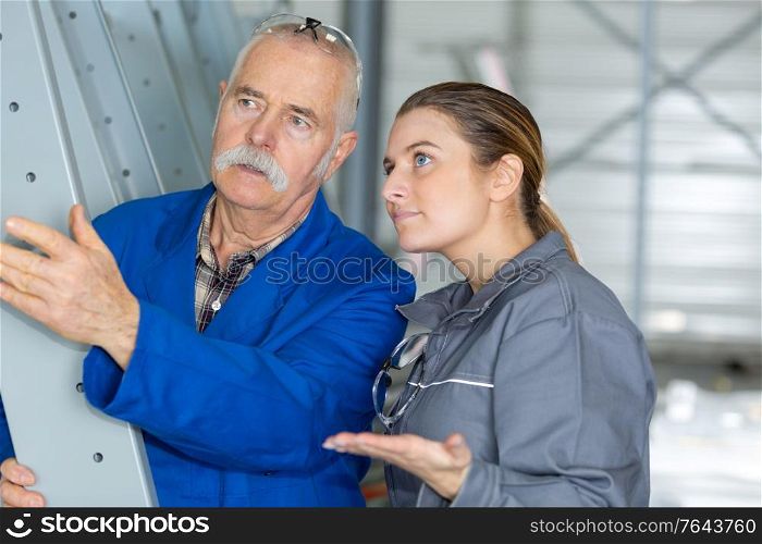 woman as craftsman trainee talking to senior colleague