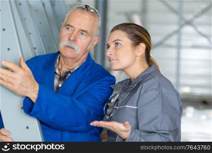 woman as craftsman trainee talking to senior colleague