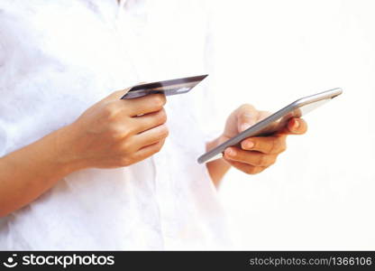 woman asian using smartphone and credit card shopping online , selective focus on hand