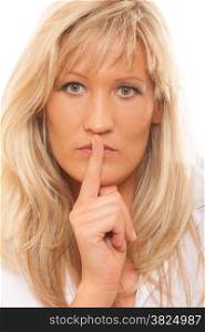 Woman asking for silence or secrecy with finger on lips hush hand gesture. Isolated
