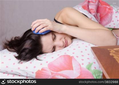 Woman asleep in bed, standing beside an alarm clock on the table, the places on the six o&#39;clock