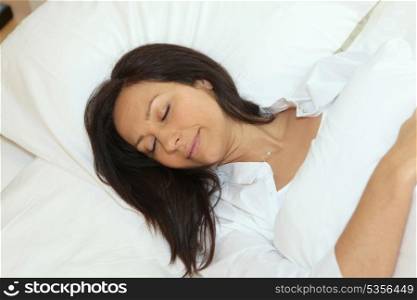 Woman asleep in her bed
