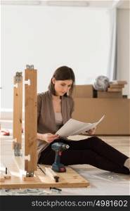 Woman Assembling Furniture In New Home