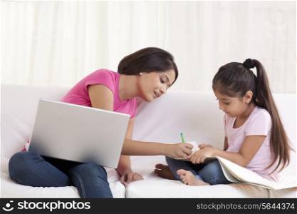 Woman assisting daughter in drawing