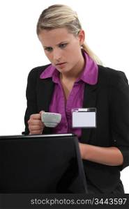 Woman at a laptop with a blank id badge