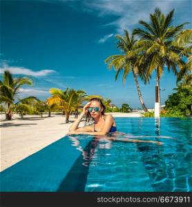 Woman at beach pool in Maldives. Woman at beach swimming pool in Maldives