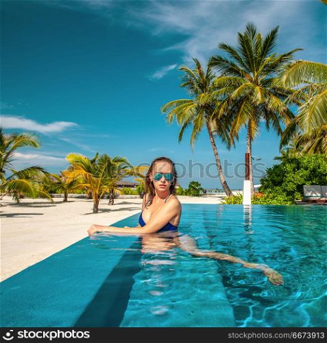 Woman at beach pool in Maldives. Woman at beach swimming pool in Maldives
