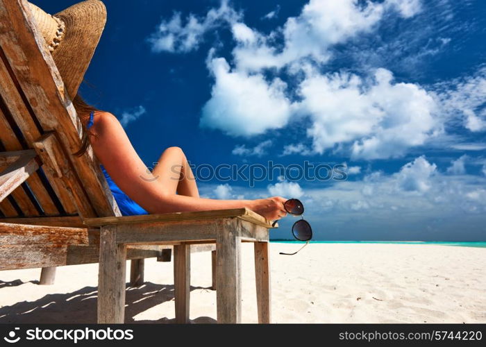 Woman at beautiful beach holding sunglasses