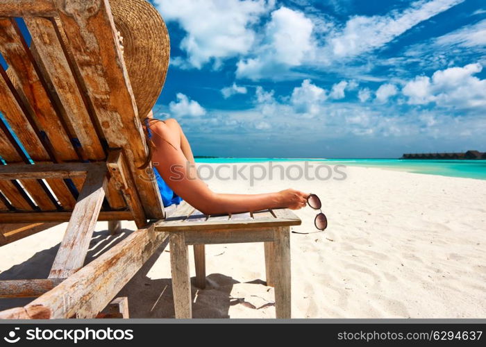 Woman at beautiful beach holding sunglasses