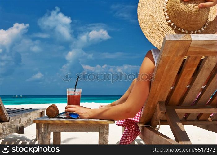 Woman at beautiful beach with chaise-lounges