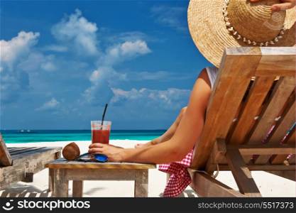 Woman at beautiful beach with chaise-lounges