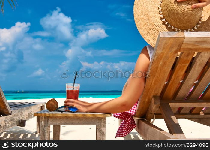 Woman at beautiful beach with chaise-lounges