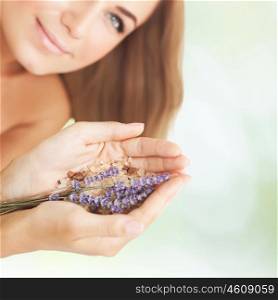 Woman at beauty salon, beautiful female at spa holds lavender flower and bath salt, aromatherapy herbal anti-stress treatment for health of mind and soul, body skin face and hair care, selective focus
