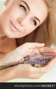 Woman at beauty salon, beautiful female at spa holds lavender flowers and bath salt, aromatherapy herbal anti-stress treatment for health of mind and soul, body skin face and hair care