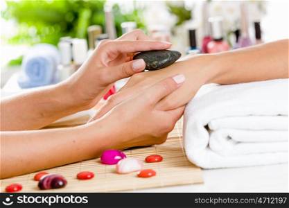 Woman at beauty salon. Close up of process of hand massage at beauty salon
