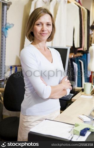 Woman at clothing store smiling