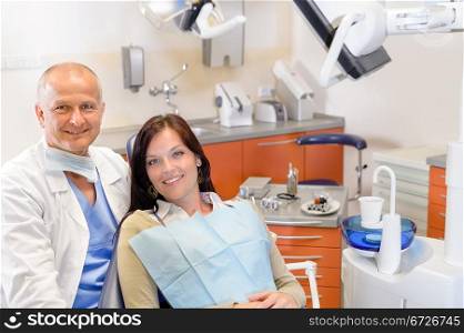 Woman at dental clinic surgery with male stomatology hygienist