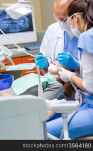 Woman at dentist surgery having dental checkup professional medical team