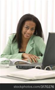 Woman At Desk Using Laptop