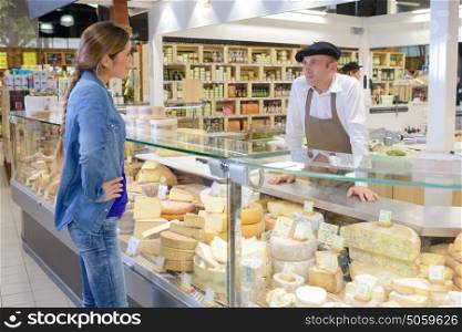 Woman at French cheese counter