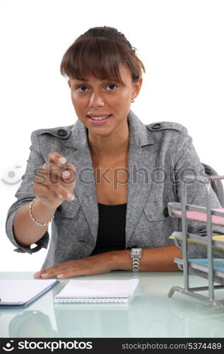 Woman at her desk reaching out