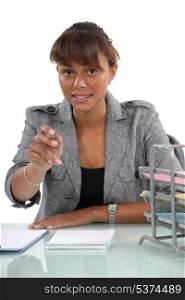 Woman at her desk reaching out