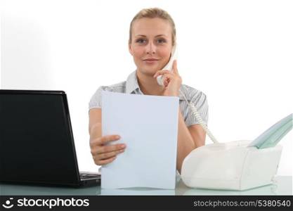 Woman at her desk using fax