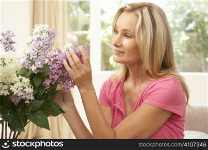 Woman At Home Arranging Flowers