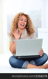 Woman at home using laptop computer