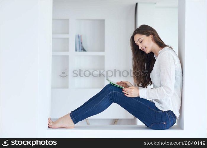 woman at home using tablet computer