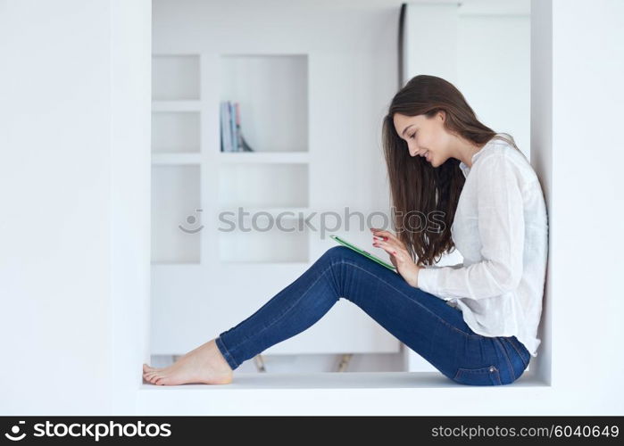 woman at home using tablet computer