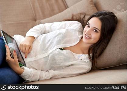 woman at home using tablet computer