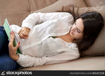 woman at home using tablet computer