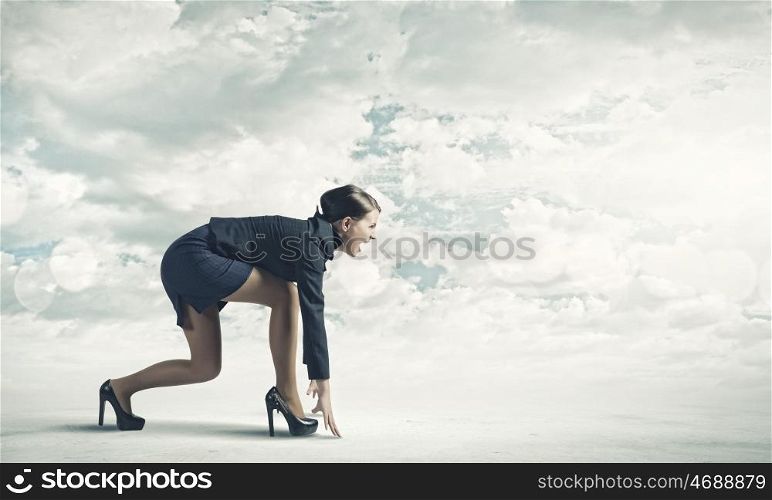 Woman at start. Side view of businesswoman in suit ready to run