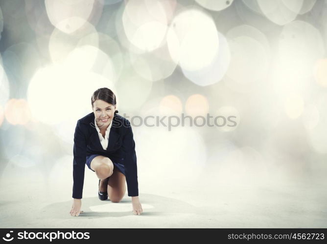 Woman at start. Young pretty businesswoman in suit ready to run