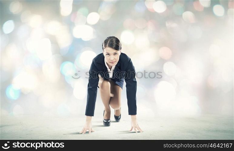 Woman at start. Young pretty businesswoman in suit ready to run