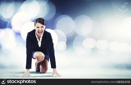 Woman at start. Young pretty businesswoman in suit ready to run