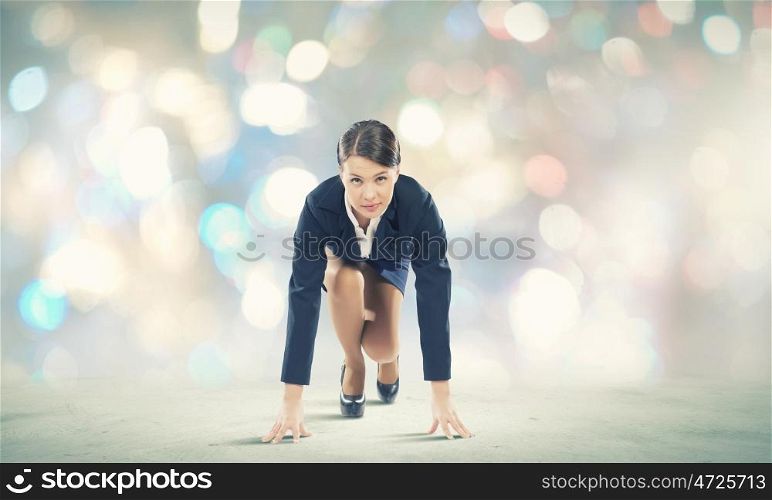 Woman at start. Young pretty businesswoman in suit ready to run