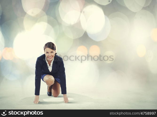 Woman at start. Young pretty businesswoman in suit ready to run