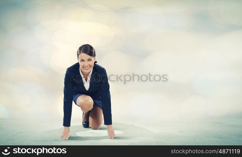 Woman at start. Young pretty businesswoman in suit ready to run