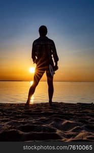 Woman at sunset holding a ukulele