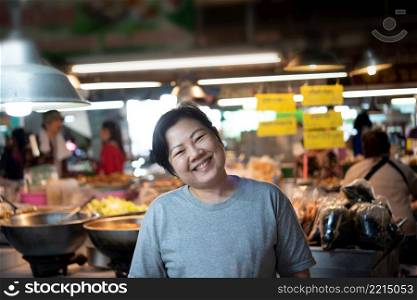 Woman at Thai street food with curry and rice shop in market. Woman at Thai street food in market