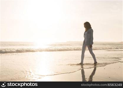 Woman at the beach. Beautiful woman enjoying sunset at the beach