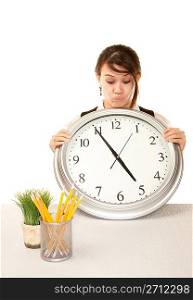Woman at work holding large clock