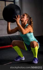 Woman athlete exercising with medicine ball