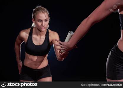 woman athletic runners passing baton in relay race