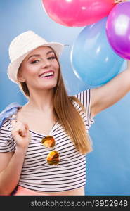 Woman attractive joyful girl playing with colorful balloons. Summer holidays, celebration and lifestyle concept. Studio shot blue background