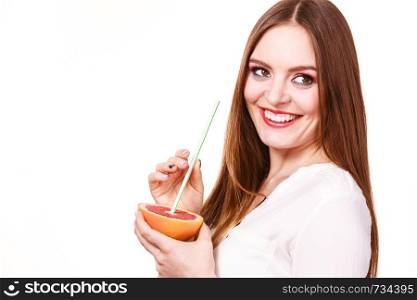 Woman attractive long hair girl colorful eyes makeup holding grapefruit citrus drinking juice from fruit. Healthy diet food. Summer vacation holidays concept. Copy space for text. Woman holds grapefruit drinking juice from fruit